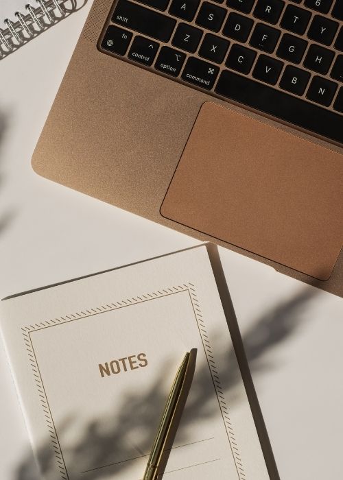 A notebook and laptop ready for an SEO planning session