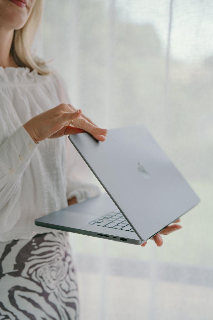 Gabrielle holding an open laptop