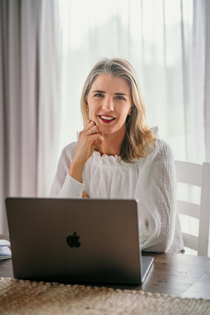 Gabrielle seated behind her laptop by the window