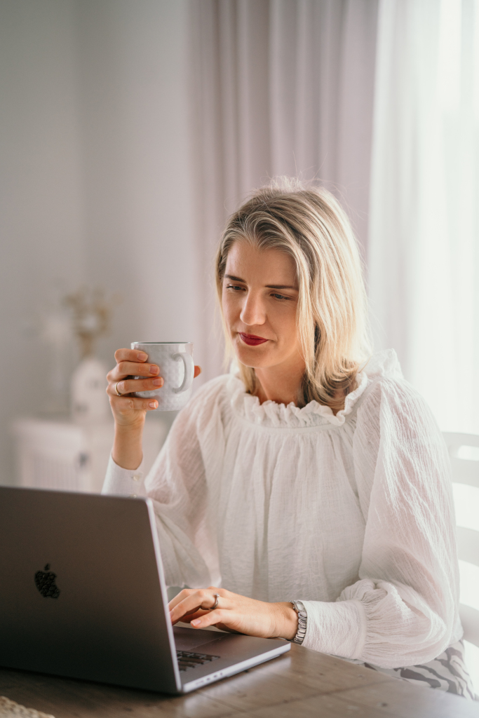 Gabrielle working on ongoing SEO at her laptop with a coffee