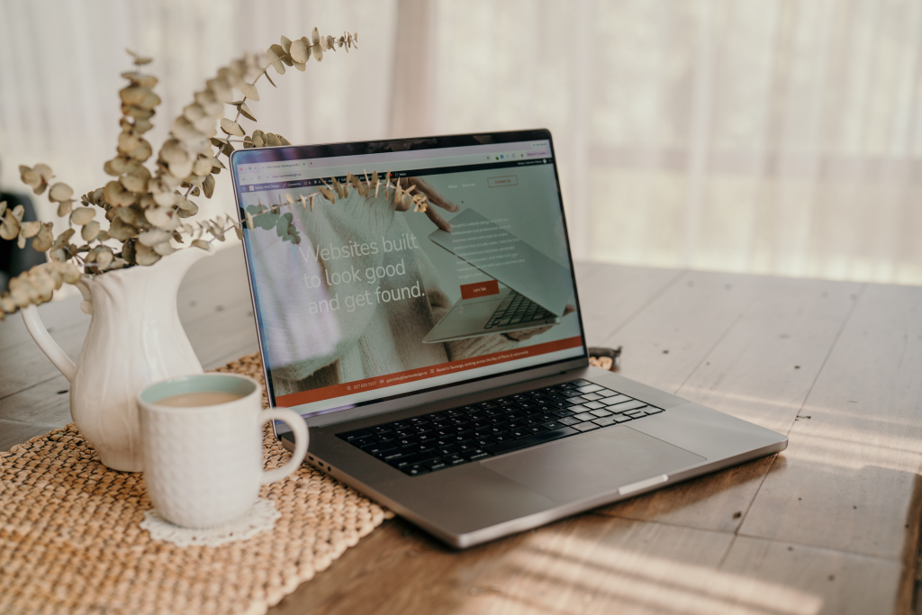 Search performance being reviewed on a laptop at a wooden desk